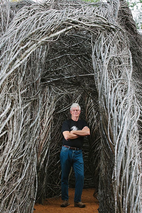 artist standing by his artwork