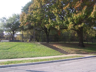 Park entrance gate by tree