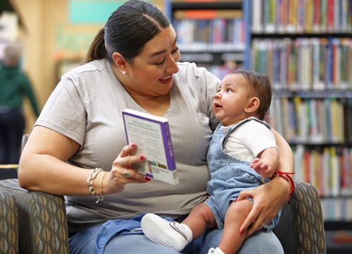 April Jacquez and her son read in the Ridglea Library