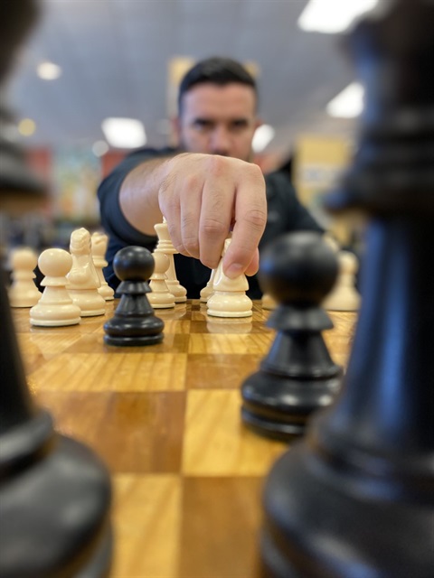 Adult playing chess