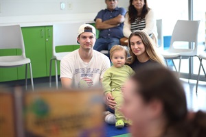 photo of parents and baby listening to a story