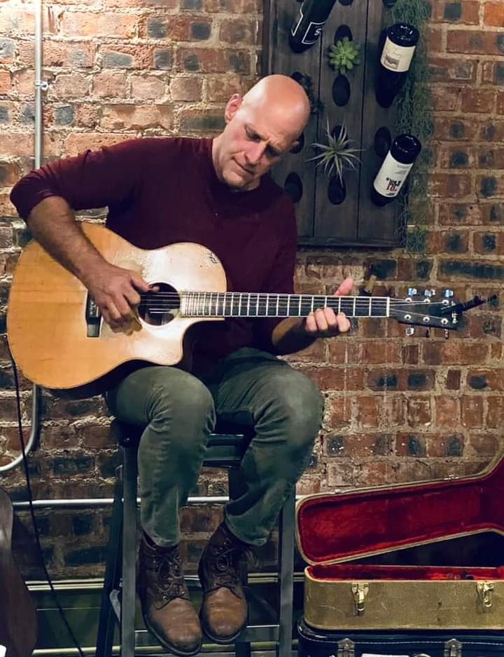 Photo of guitarist playing music