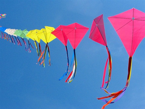 Colorful kites flying in a blue sky