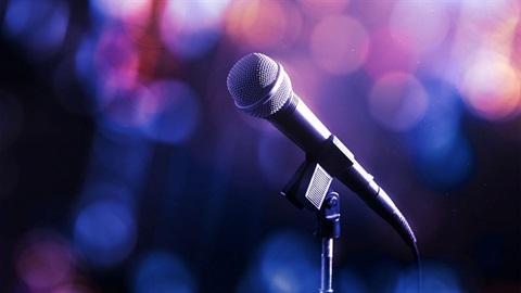 Photo of a microphone on stage to set the scene for karaoke