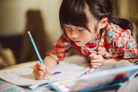 photo of a girl drawing pictures