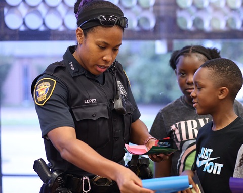 Officer Lopez works with youth at the Wedgwood Library