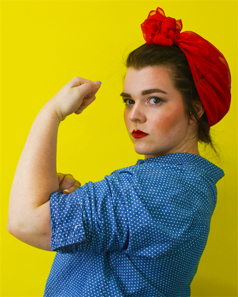 Woman flexing like the iconic Rosie the Riveter image