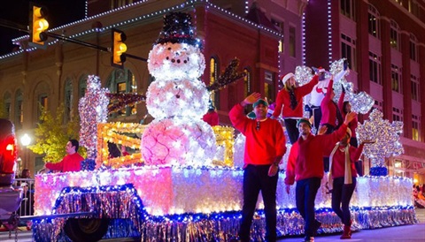 a parade float with people waving