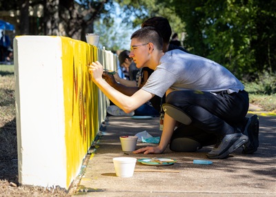 Young man painting a mural