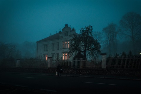 eerie looking house with low fog around it