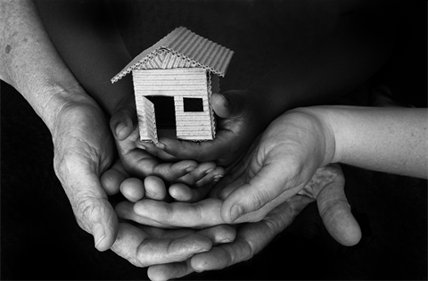 I need help hands of family holding cardboard house